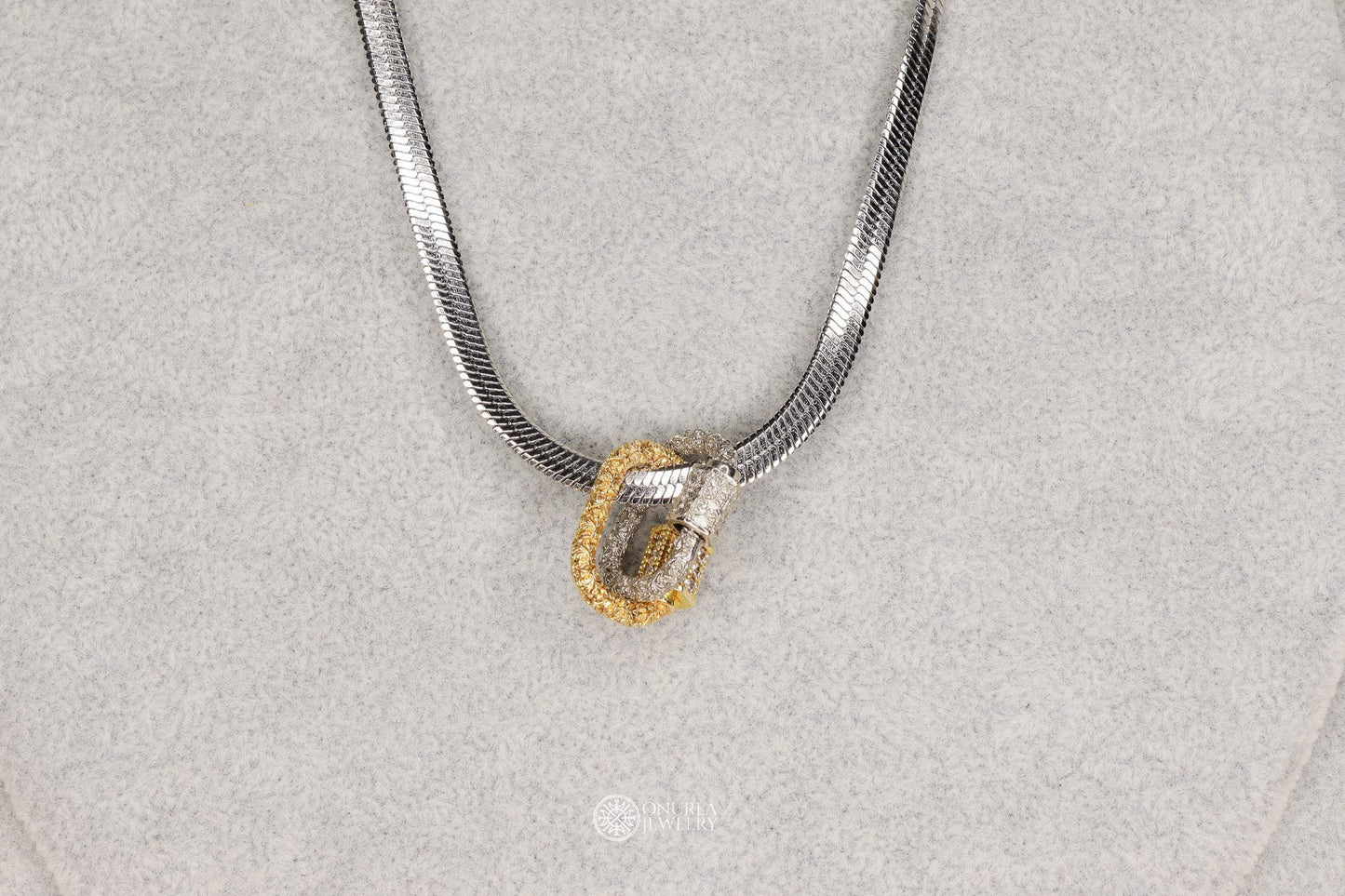 Onurla men's necklace with interlocking silver and gold-tone rings, one encrusted with stones. Features a flat Italian snake chain.