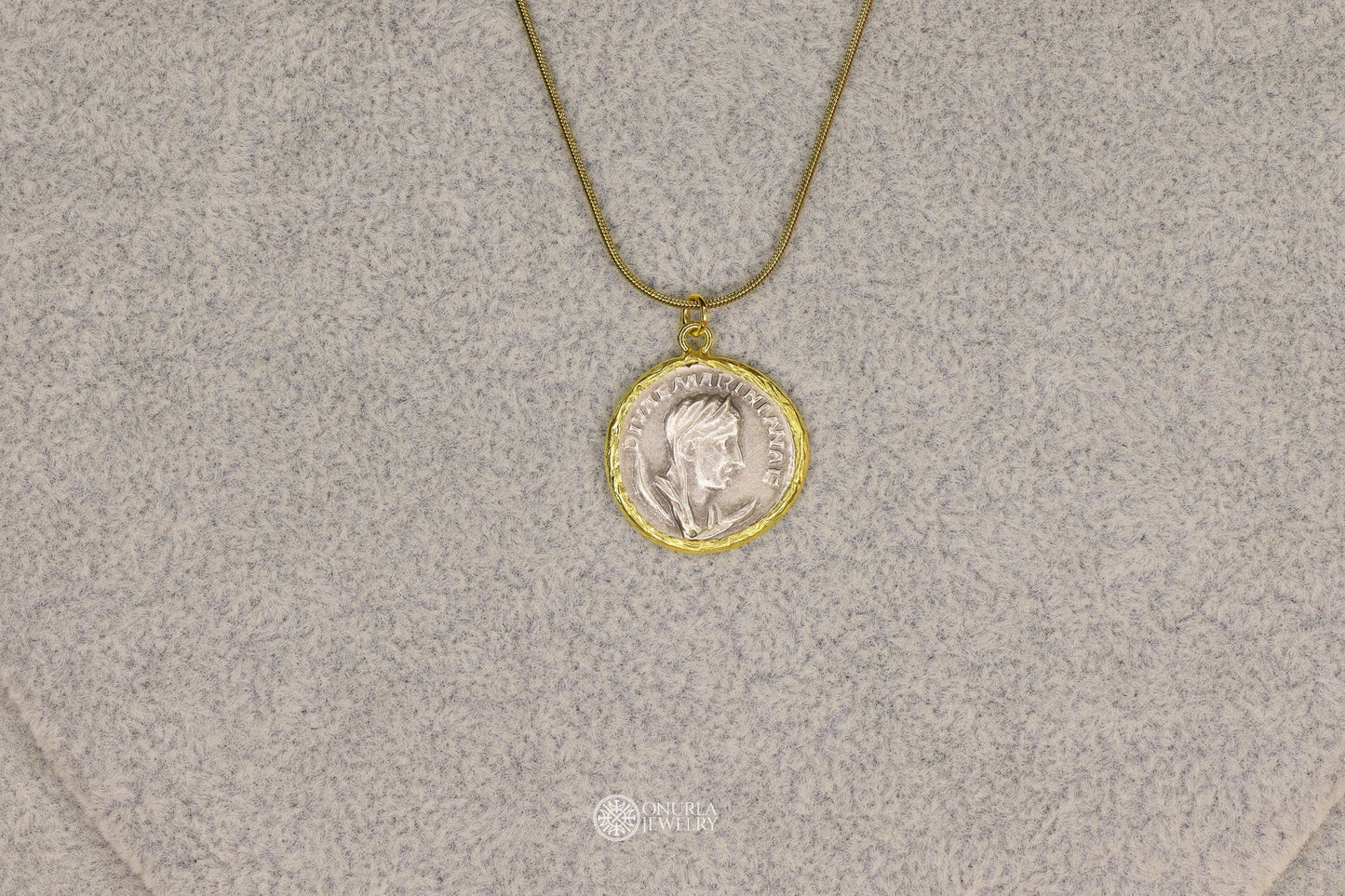 Onurla gold-tone necklace with a silver-tone Roman coin pendant featuring a profile portrait and inscription.