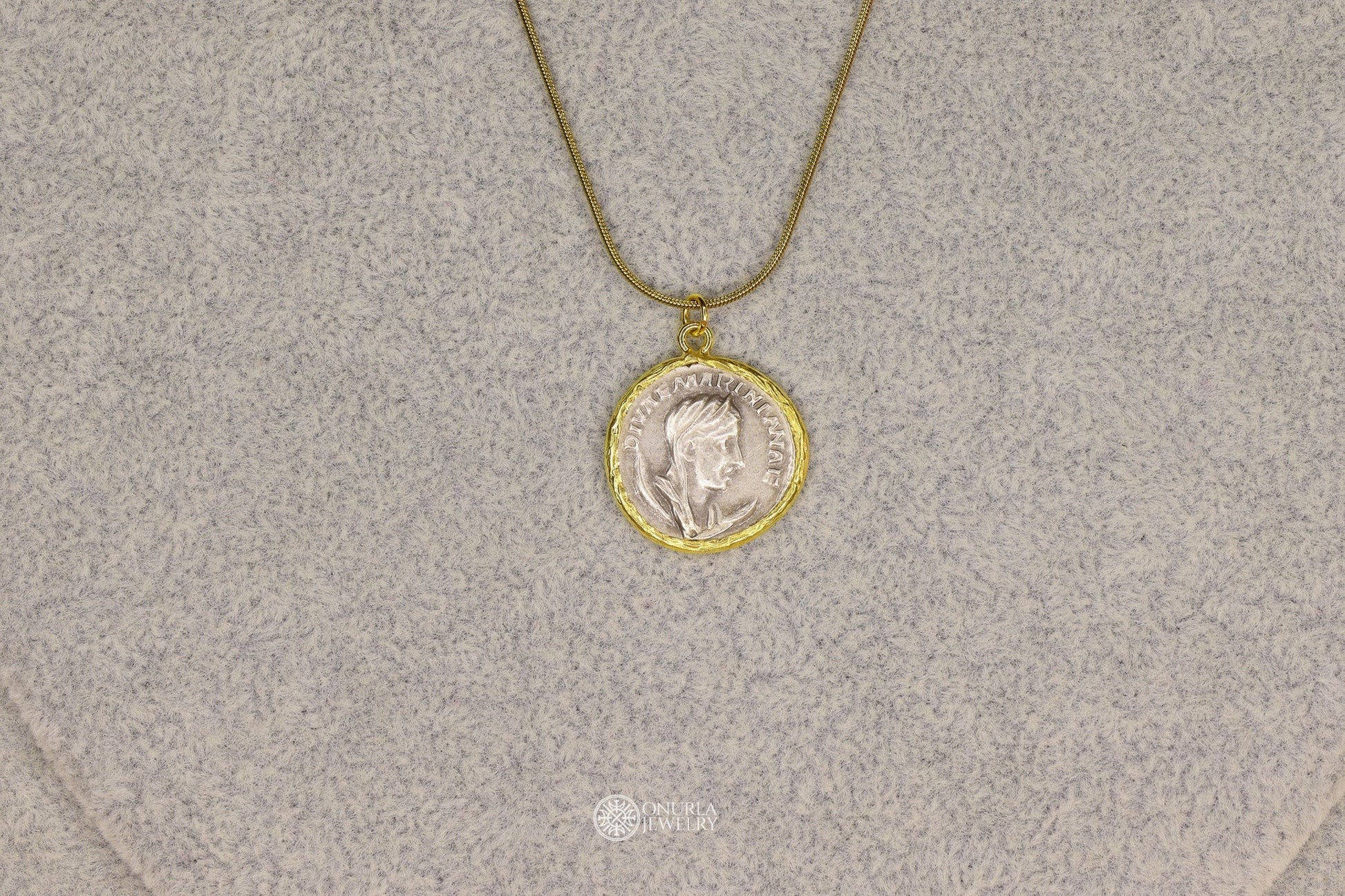 Onurla gold-tone necklace with a silver-tone Roman coin pendant featuring a profile portrait and inscription.